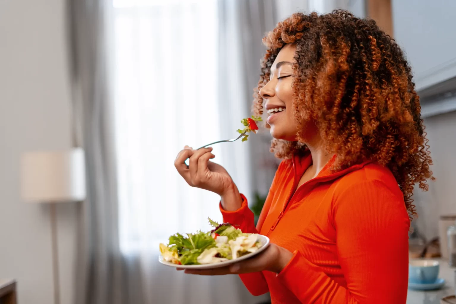 african american woman enjoying fresh salad embra utc